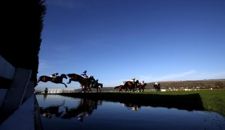 Horses jump over water at Cheltenham